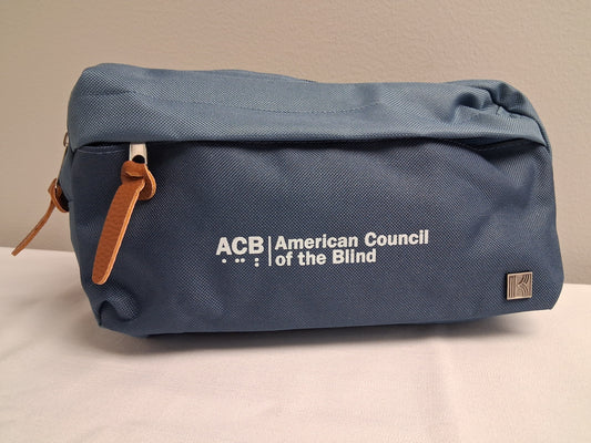 Blue fanny pack with 'ACB American Council of the Blind' logo on a beige background