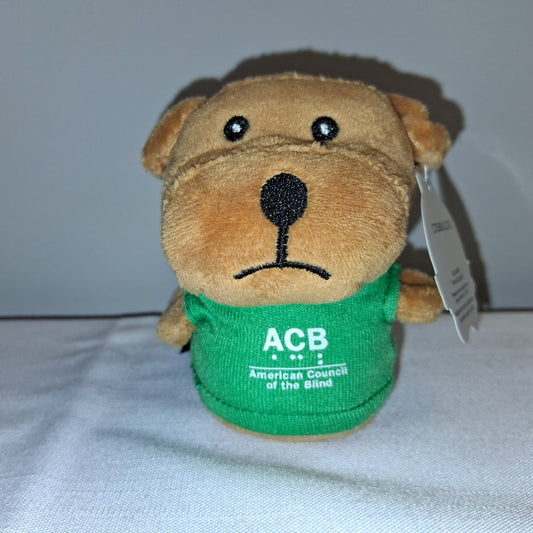 Plush dog toy with a green shirt and 'ACB' logo on a white background
