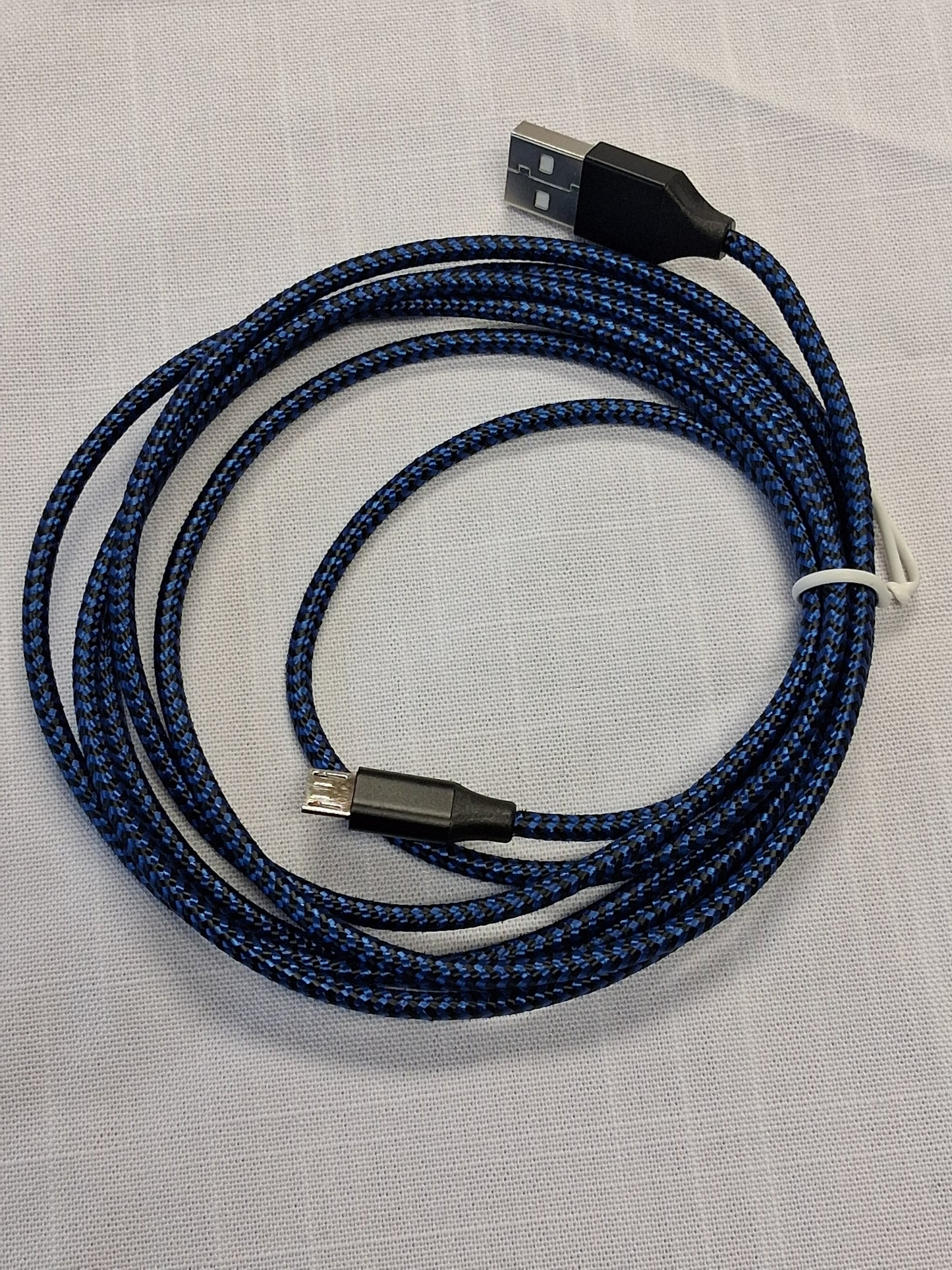 Coiled blue USB cable on a light gray background