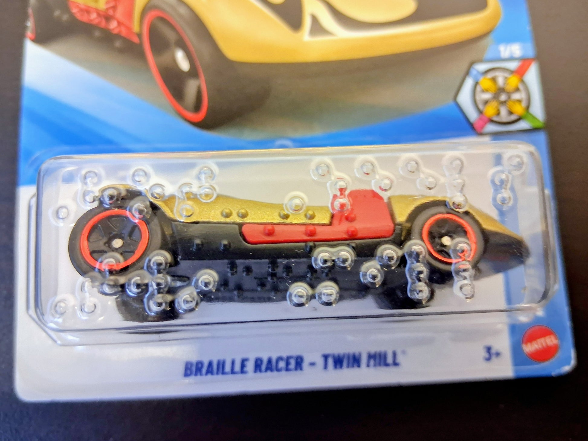 Toy car with 'Barrillte Racer' branding on a clear plastic card.
