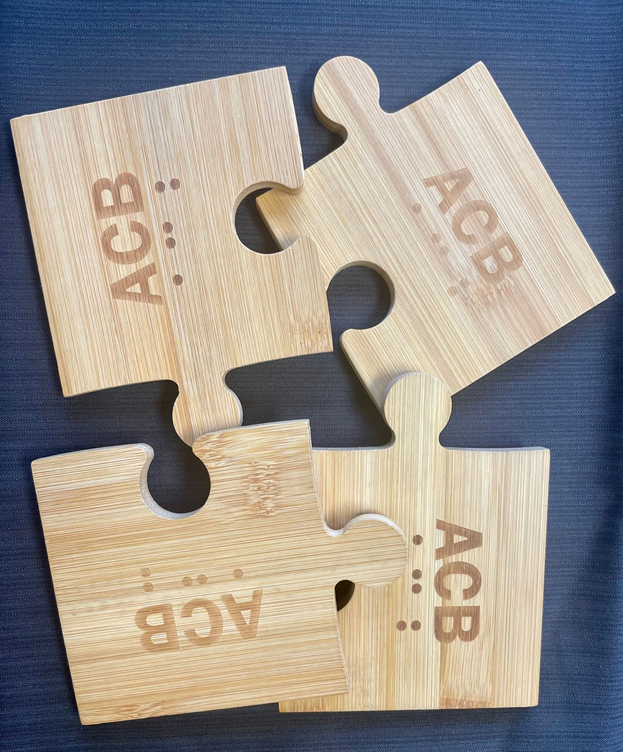 Unassembled bamboo puzzle coaster (4 pieces each with ACB logo)