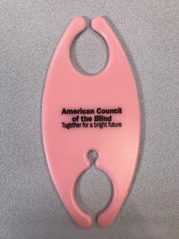 Pink cord and cable organizer with American Council of the Blind words in back